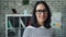 Portrait of beautiful office worker lady in glasses smiling looking at camera