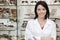 Portrait of a beautiful optometrist with arms crossed in store