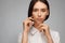 Portrait of a beautiful pacified woman in a white shirt on a light background