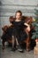 Portrait of a beautiful pensive girl in black near the Christmas tree at Christmas