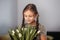 Portrait of beautiful pretty girl with white flowers tulips. Indoor photo