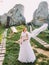 Portrait of beautiful redhair bride posing near rocks. Honeymoon at Carpathians in Tustan fortress