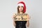 Portrait of a beautiful sad brunette woman in christmas hat and festive black dress holding a cardboard sign `unhappy new year ` o