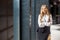 Portrait of beautiful self-confident successful businesslady standing with crossed hands and smiling at camera. business center,