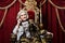 Portrait of beautiful senior queen on throne