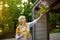 Portrait of beautiful senior woman with curly gray hair. Old woman tending about plants and flowers near her home