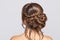 Portrait of a beautiful sensual light brown haired woman with a wedding hairstyle and nude make-up in a beauty salon. Wedding