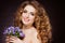 Portrait of a beautiful sensual redheaded girl with flowers in t