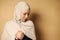 Portrait of a beautiful serene Muslim woman looking down and holding her fist in front of her