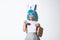 Portrait of beautiful silly japanese girl in blue wig and rabbit ears, dressed-up for halloween party, smiling