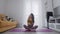 Portrait of a beautiful slim sporty woman practicing yoga on a mat. Woman warms up before training