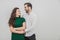 Portrait of beautiful smiling couple posing at studio over white background.