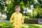 Portrait of beautiful smiling kid boy. Happy child against green tree background. Kid playing outdoors. Laughing healthy