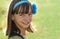 Portrait of a beautiful smiling teen girl of European appearance with the decoration on dark hair in a field.