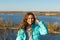 Portrait of a beautiful smiling teen girl on a lake background