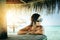 Portrait of beautiful smiling woman under parasol at tropical island