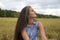 Portrait of a beautiful swarthy caucasian young woman on a background of a field, nature