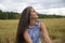 Portrait of a beautiful swarthy caucasian young woman on a background of a field, nature