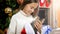 Portrait of beautiful teenage girl with kitten sitting under decorated Christmas tree