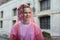 Portrait of beautiful teenager girl walking in rain dressed in raincoat