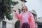 Portrait of beautiful teenager girl walking in rain dressed in raincoat