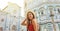 Portrait of beautiful tourist woman in Florence with Cathedral and Baptistery on the background. Panoramic view of traveler girl