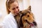 Portrait of beautiful veterinarian with dog