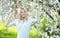 Portrait of beautiful woman in blooming spring tree