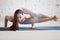 Portrait of beautiful woman doing eight angle handstand pose