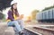 Portrait of beautiful woman engineering using tablet with wear hardhat in front of train garage