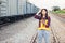 Portrait of beautiful woman engineering using tablet with wear hardhat in front of train garage