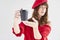 Portrait of Beautiful woman with long hair wearing red hat and sweater holds paper disposable coffee cup.