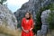 Portrait of a beautiful woman in long red dress in mountains. Ai-Petri mountain