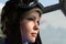 Portrait beautiful woman pilot in aviator helmet with goggles