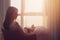 Portrait of beautiful woman sitting on chair enjoying sunrise