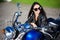 Portrait of beautiful woman sitting on retro motorbike