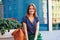 Portrait of beautiful woman sitting on round bench in the city d