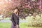 Portrait of a beautiful woman among spring foliage and flowers