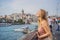 Portrait of beautiful woman tourist with view of Galata tower in Beyoglu, Istanbul, Turkey. Turkiye