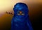 Portrait of beautiful woman wearing blue tuareg scarf. Young girl in national costume of african tribal nomads. Blue ethnic Turban