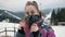 Portrait of a beautiful woman in the winter mountains, a tourist puts on a bandana mask on his face