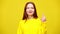 Portrait of beautiful worried young woman crossing fingers posing at yellow background. Stressed charming Caucasian lady