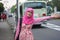 Portrait of beautiful young Asian muslim woman in street of Kyoto waving hand gesture for stopping city bus