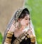 Portrait of beautiful young asian Thai girl with black and gold traditional India dress