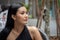 Portrait of  beautiful  young asian woman in a black dress looking away in city outdoor