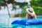 Portrait beautiful young asian woman happy smile relax in swimming pool at hotel resort neary sea ocean beach on blue sky