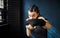 Portrait beautiful young boxing woman training punching in gym