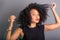 Portrait of beautiful young brunette woman messing with her hair. Dressed in black