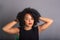 Portrait of beautiful young brunette woman messing with her hair. Dressed in black