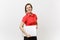 Portrait of beautiful young business teacher woman user in red shirt, glasses holding laptop pc computer underarm